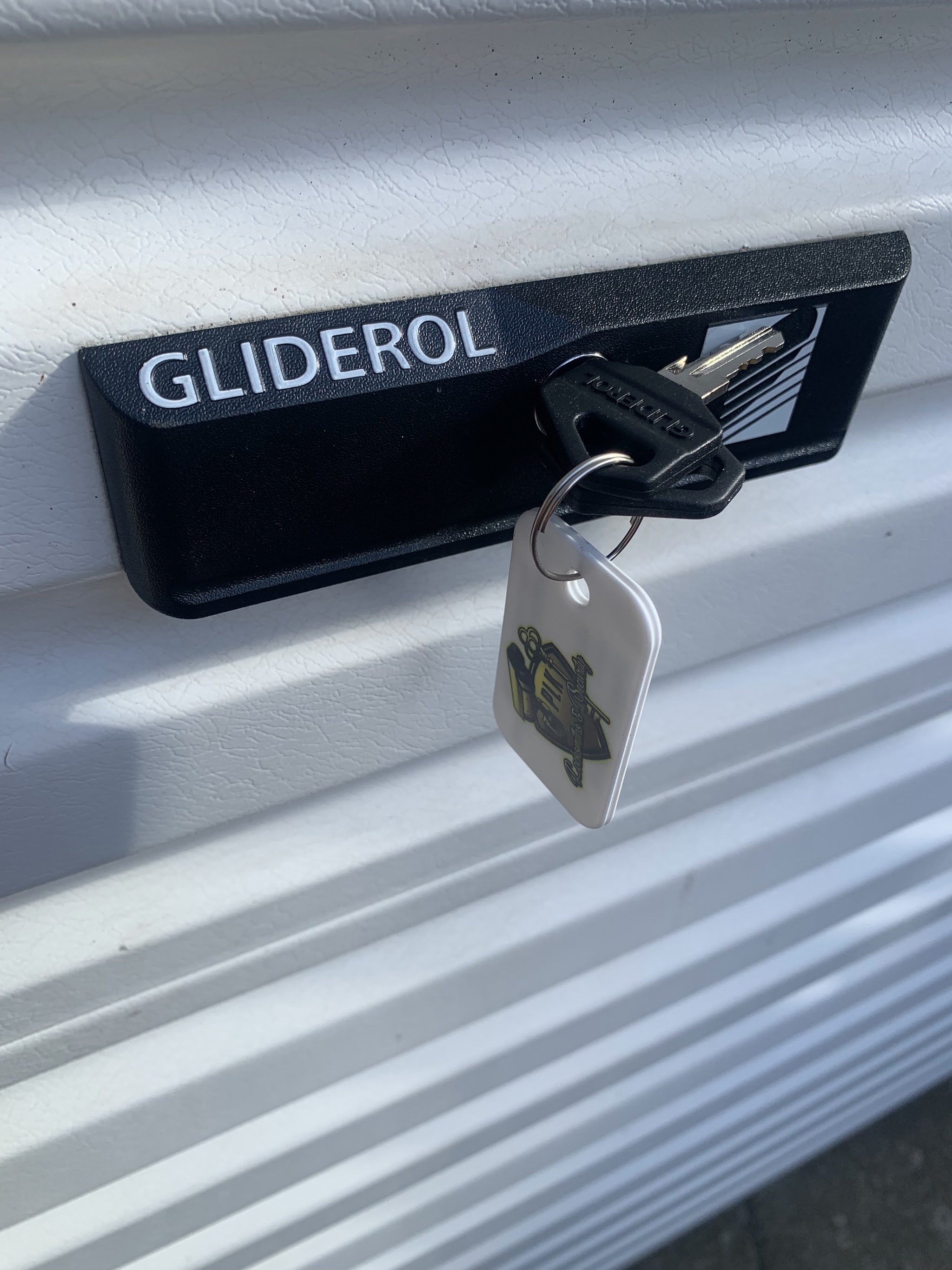 A key with the PLK keyring in a Gliderol garage door lock