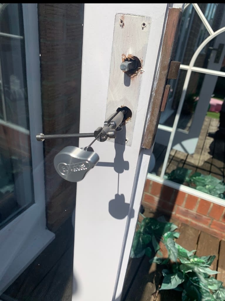 A lock cylinder being drawn out of a patio door